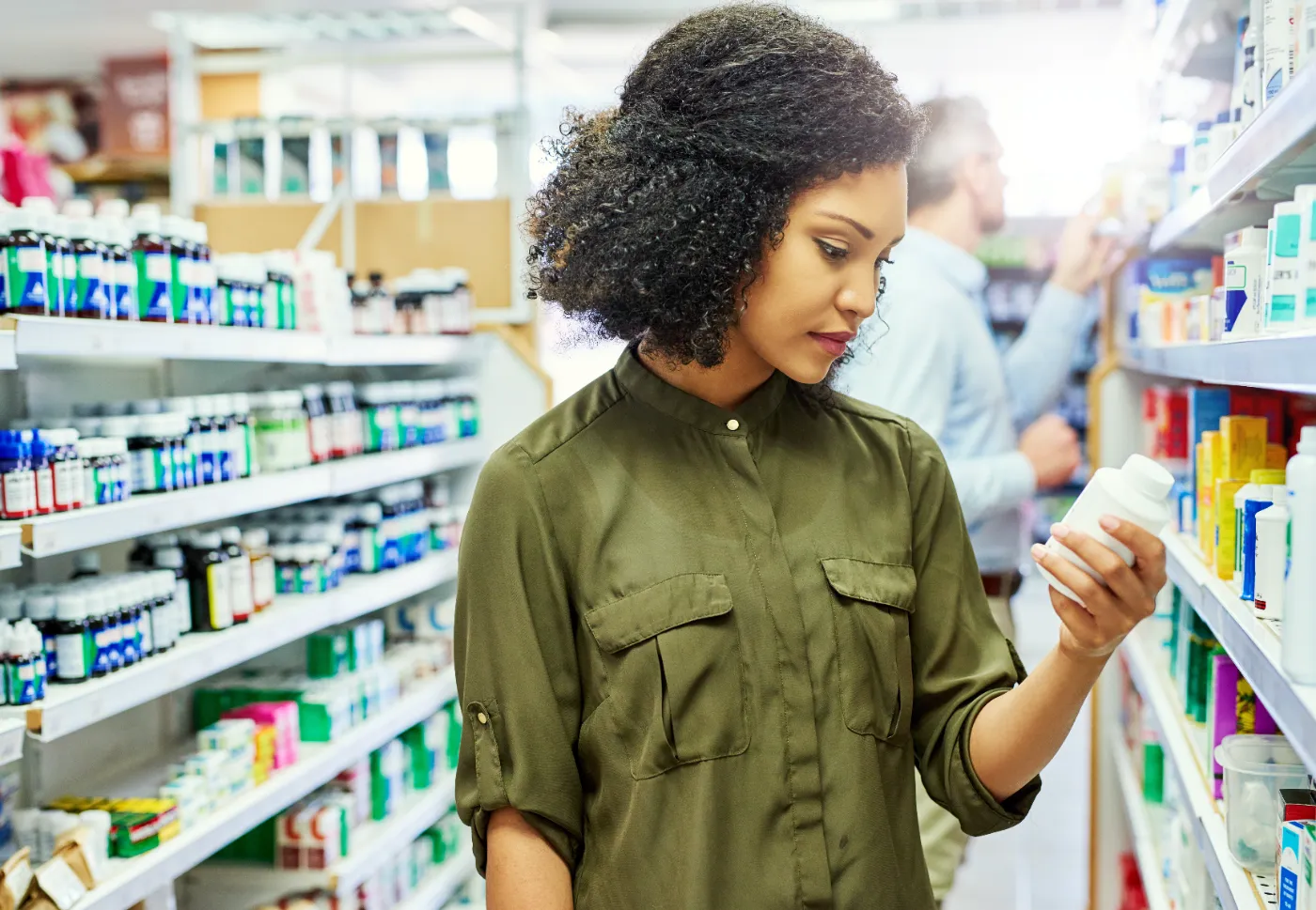 Woman in Pharmacy looking at labels 1